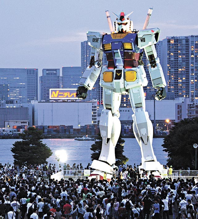 A 18-meter (59 feet)-tall Gundam appears at a Tokyo park. The full-size model of the Japan's most popular robot animation series character has been built, marking the 30th anniversary of the start of its TV broadcasting in 1979. Gundam that features giant robots in the era of space wars, is turning 30 this year. (AP Photo/Koji Sasahara