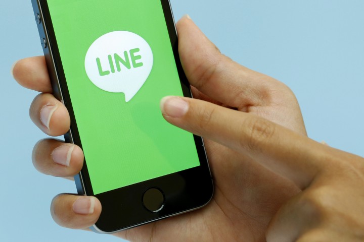 The loading page for a messaging and calling service application operated by Line Corp., controlled by Naver Corp., is displayed on an Apple Inc. iPhone 5s for a photograph during an event for the company's new services in Tokyo, Japan, on Wednesday, Aug. 27, 2014. Line will offer a group discount service from Aug. 28 in Japan, Takeshi Shimamura, an executive director at the company, told reporters in Tokyo today. Photographer: Kiyoshi Ota/Bloomberg