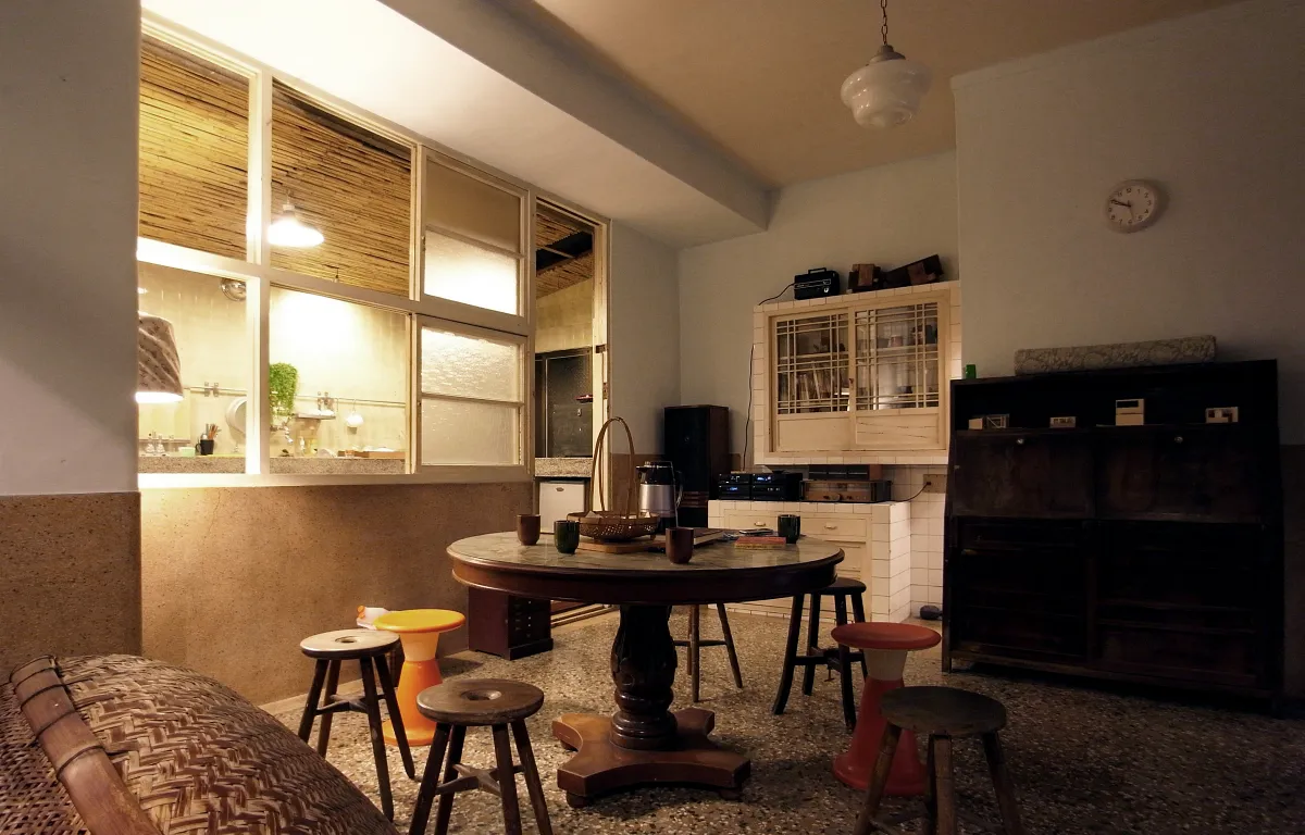 「謝宅」保留紅磚、木門與 85 度斜角樓梯，八間旅宿皆承載百年家族故事與歲月印記。